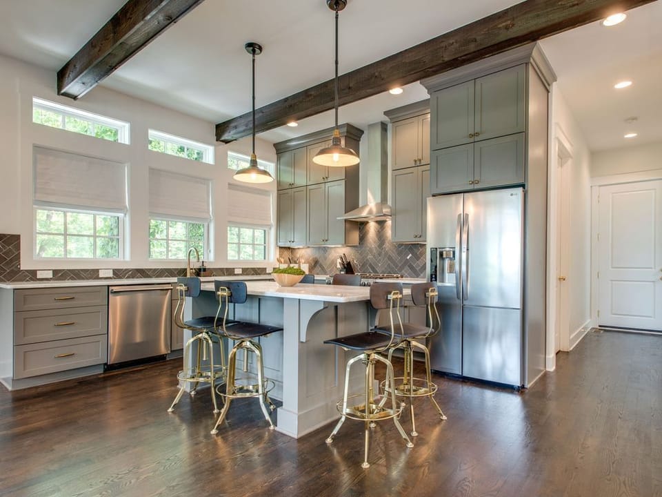 - Cook in a spacious kitchen with stainless appliances and bright windows   - Large island with seating creates the perfect gathering spot   - Modern lighting and open layout make meal prep feel effortless