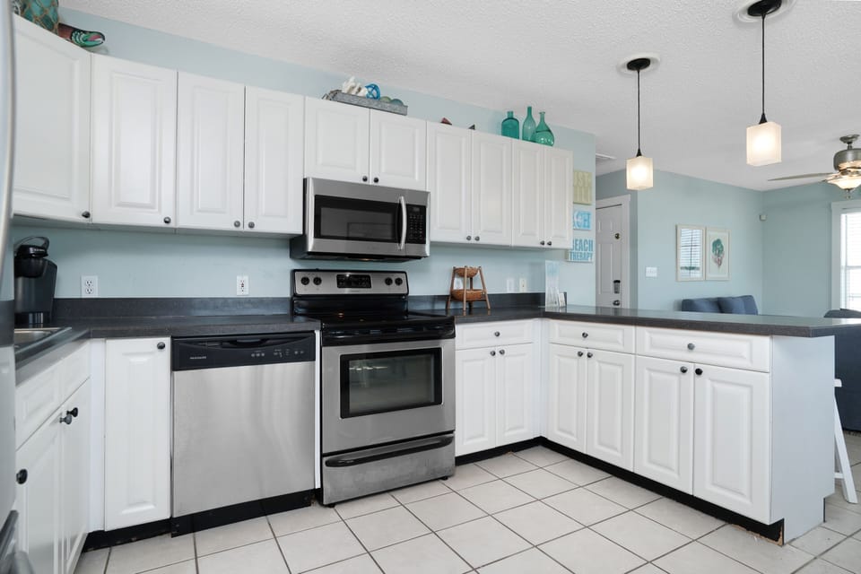 Your fully equipped kitchen features stainless appliances, granite counters, and calming coastal colors for memorable meals.