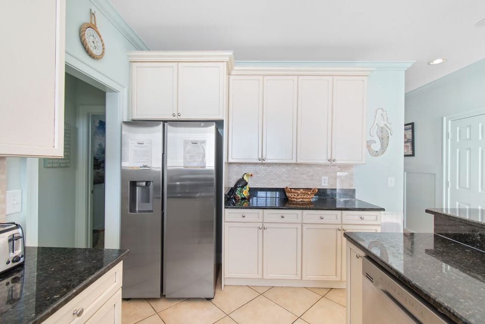 Your fully-equipped kitchen awaits with granite counters, stainless appliances, and crisp white cabinetry for memorable meal prep.