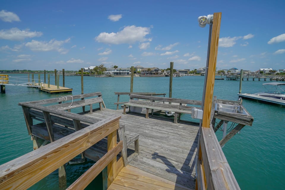 Private waterfront dock with inlet waters and seating areas, perfect for your morning coffee or sunset relaxation.