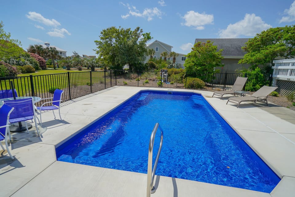 Dive into your private blue oasis with sparkling pool waters and comfortable poolside seating for sunny afternoons.