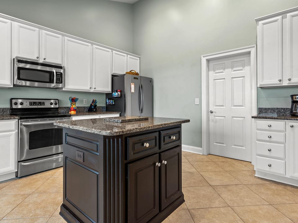Your spacious kitchen awaits with granite countertops, stainless steel appliances, and a central island perfect for meal prep and gathering.