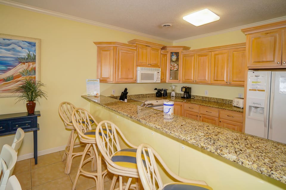 Cook up delicious meals in your spacious kitchen featuring granite counters, modern appliances, and a breakfast bar perfect for casual dining.
