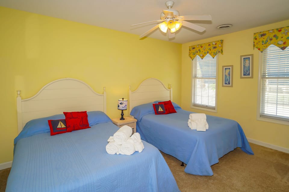 Rest peacefully in your cheerful bedroom, where sunny yellow walls and nautical touches create the perfect coastal retreat for you.