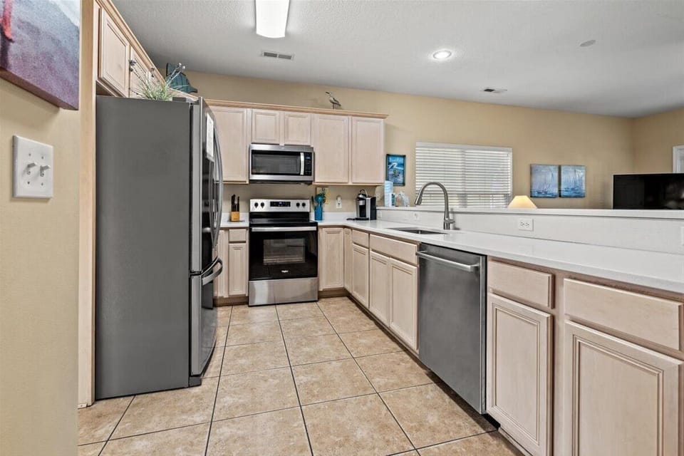 Prepare your favorite meals in this fully equipped kitchen with stainless steel appliances, ample counter space, and everything you need for home cooking.