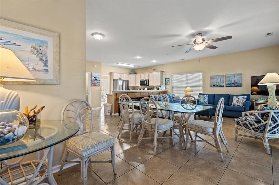 Bright coastal living awaits in this spacious open-plan retreat, where you'll gather around the glass dining table and unwind on comfortable sofas.