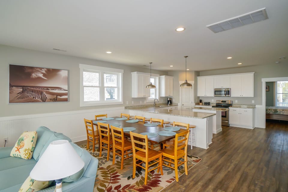Your spacious open-plan living area flows seamlessly from cozy lounge to dining table and fully-equipped kitchen, perfect for family gatherings.