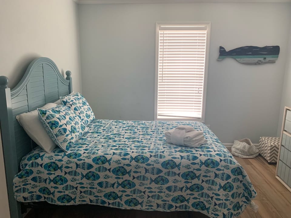 Drift off in this coastal-themed bedroom where ocean-inspired bedding and charming whale decor create your perfect seaside retreat.