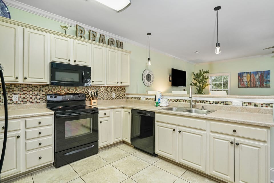 Your fully equipped kitchen awaits with granite counters, mosaic tile backsplash, and modern appliances ready for memorable meals.