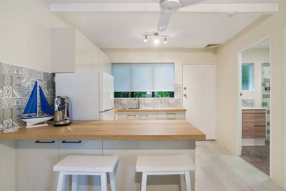 The fully equipped kitchen features a Nespresso coffee machine, along with a refrigerator/freezer, electric stove, microwave, kettle, and all the essential kitchenware, making it easy to prepare meals and enjoy the convenience of home during your stay in 