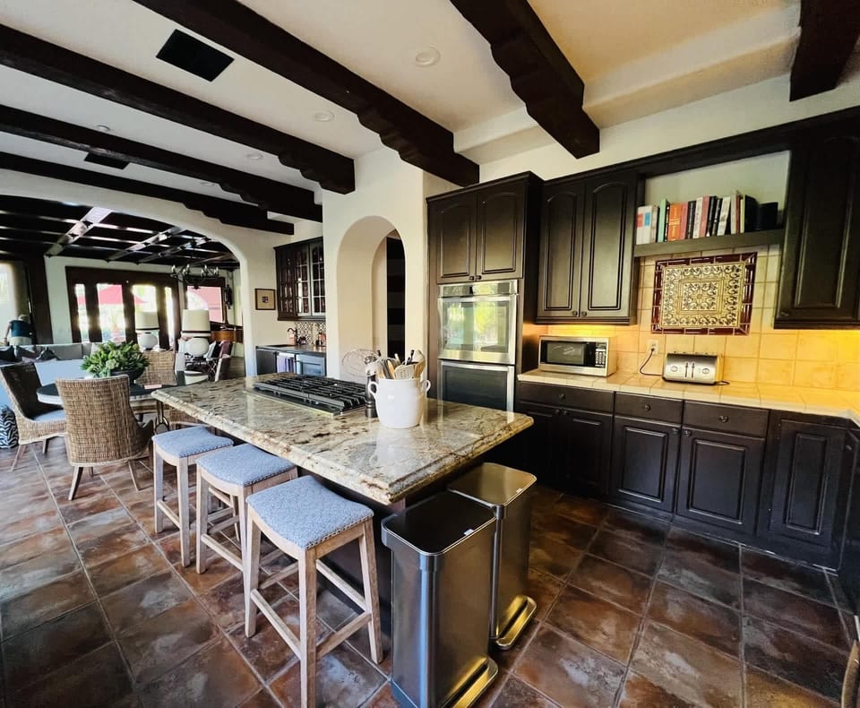 Step into a chef's paradise w/ this stylish, well-appointed modern kitchen w/ bar seating for three. Featuring stainless steel appliances, sleek countertops, & ample cabinet space, it's the perfect space to cook creating delicious memories together.