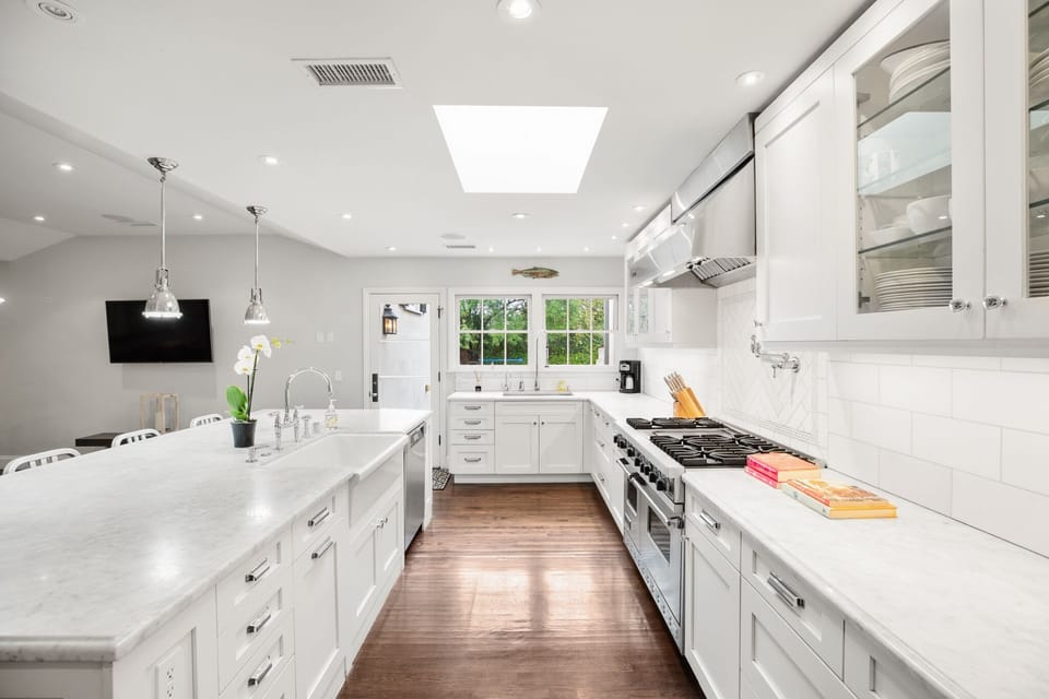 Marble countertops and Viking range, two farm sinks 