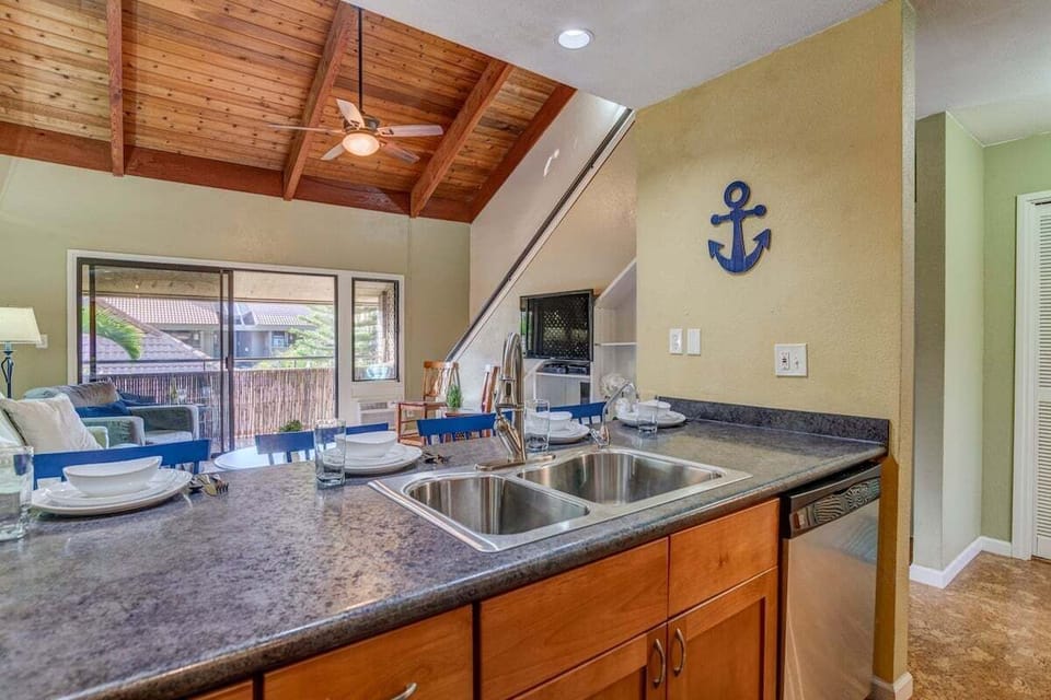 Kitchen with granite counters, stainless appliances, and ample space for preparing island meals.