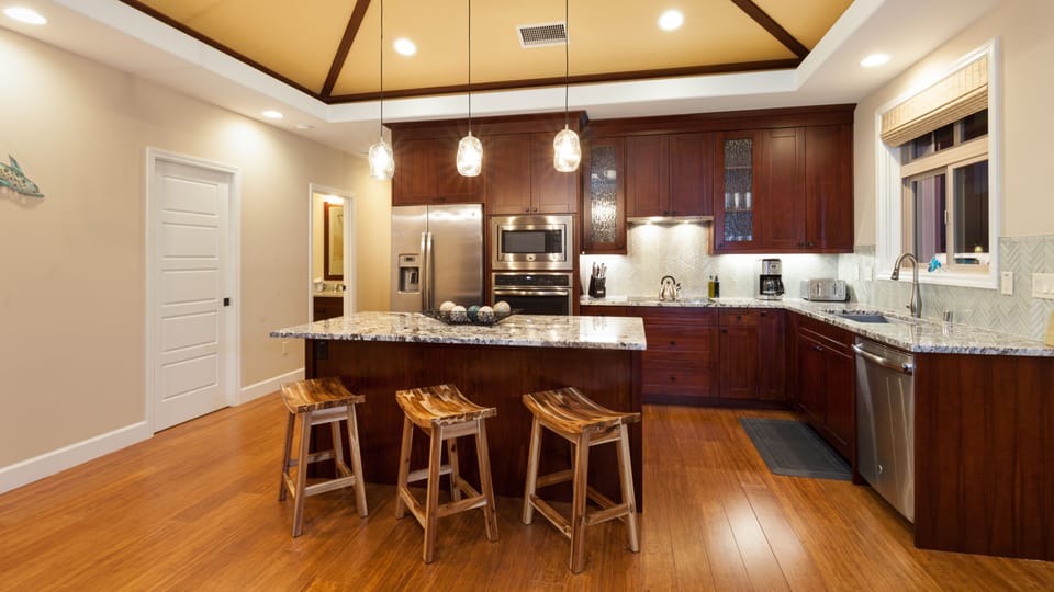 Gourmet kitchen with large island and high-end appliances. Stocked with cooking essentials, spices & oils