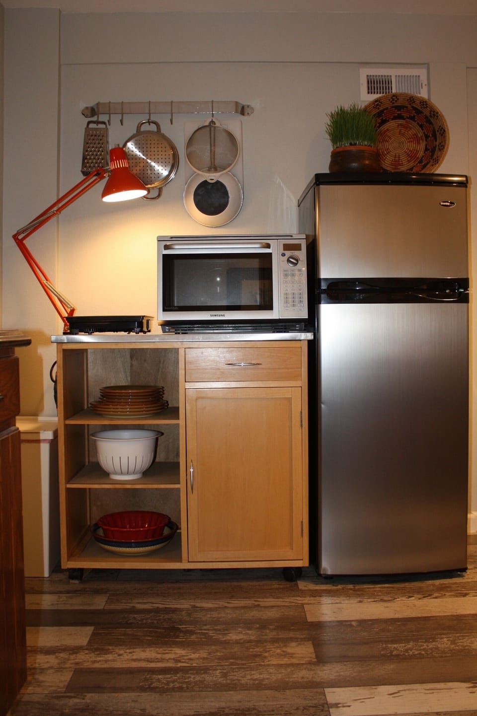 Kitchen - Refrigerator/freezer, microwave/toaster oven, and induction cooktop.