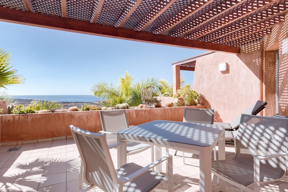 Large terrace with dining table and seaview
