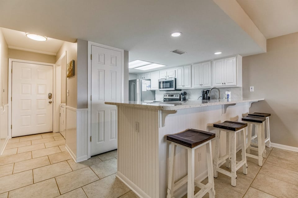 Kitchen with breakfast bar and open layout at Wind Drift Orange Beach