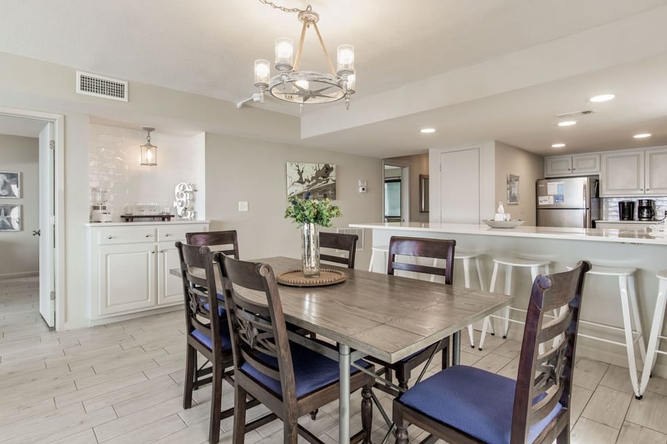 Dining table and breakfast bar at Wind Drift Orange Beach condo