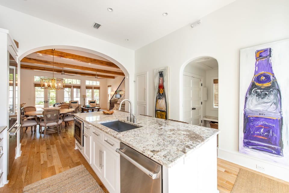 Kitchen Island, Dishwasher, Refrigerator, Dining Table, and Chairs.