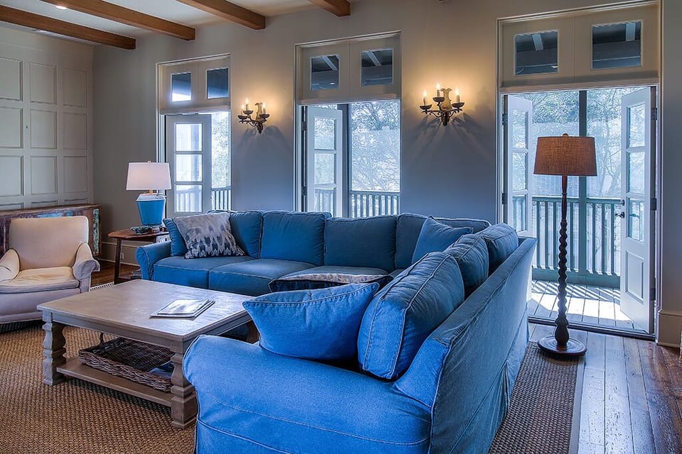 Living Area with Sofas, Coffee Table, Arm Chair, and French Doors.