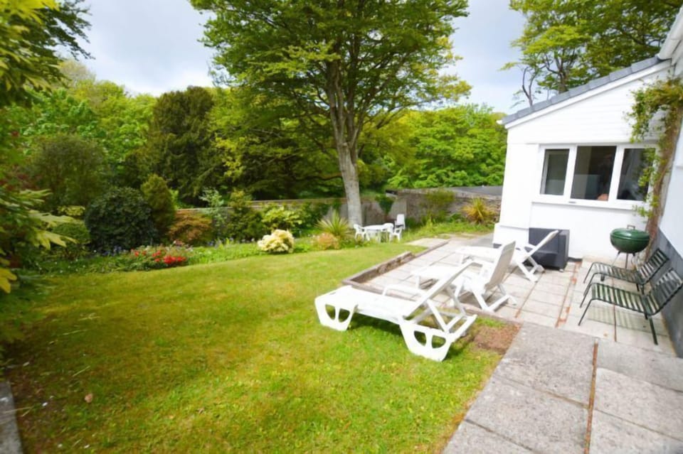 A charming walled garden with well-established shrubs and lawns. Patio area with barbecue