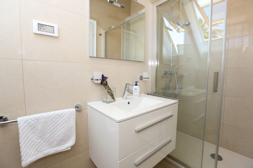 Villa White & Co  |The modern bathroom has shower cabin, hairdryer and WC