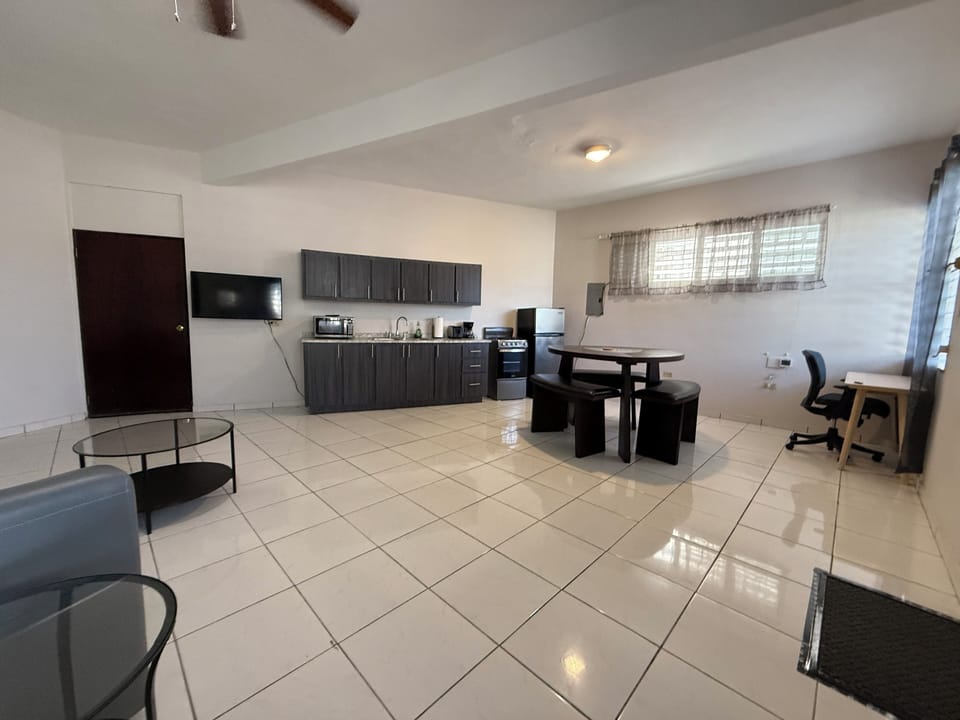 Roomy  with living room, dining, kitchen, and work station areas.