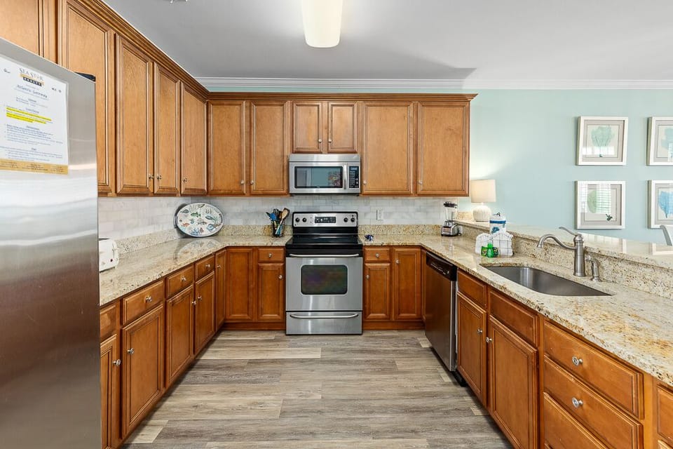 Your fully equipped kitchen offers granite countertops, stainless steel appliances, and warm wood cabinetry for all your culinary adventures.