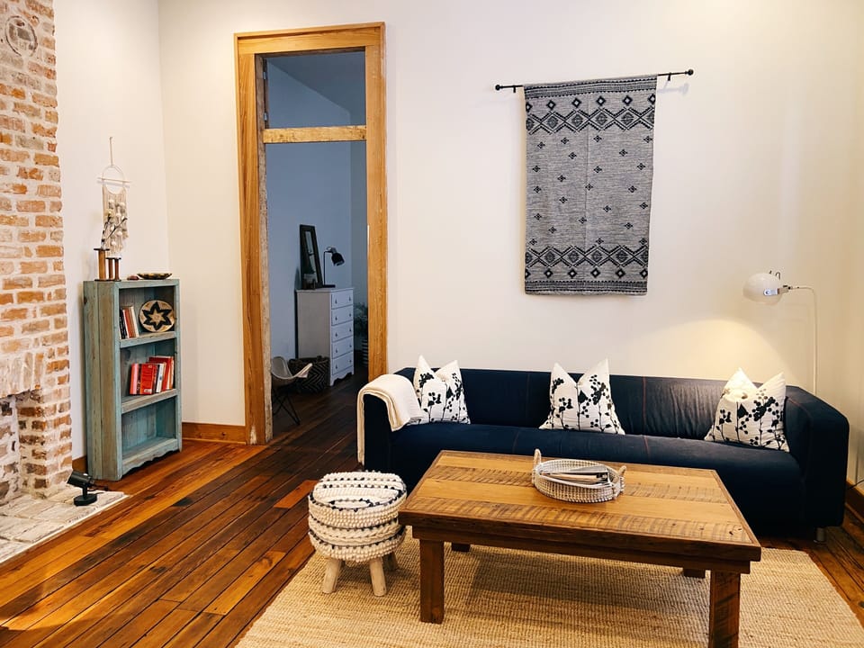 Living room with large sofa and television. Custom woodwork throughout.