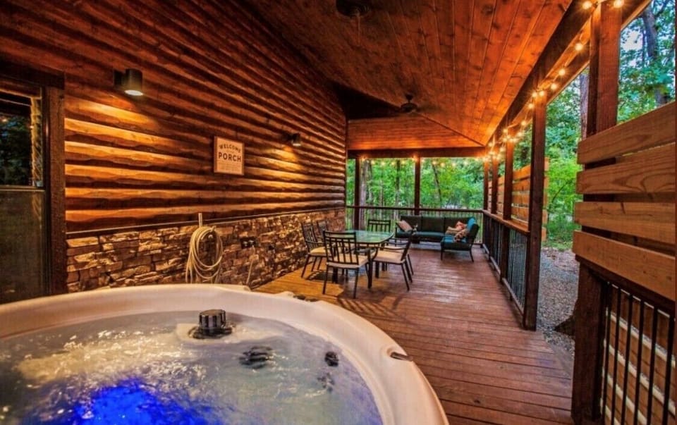 Back porch with sitting area, dining table and hot tub