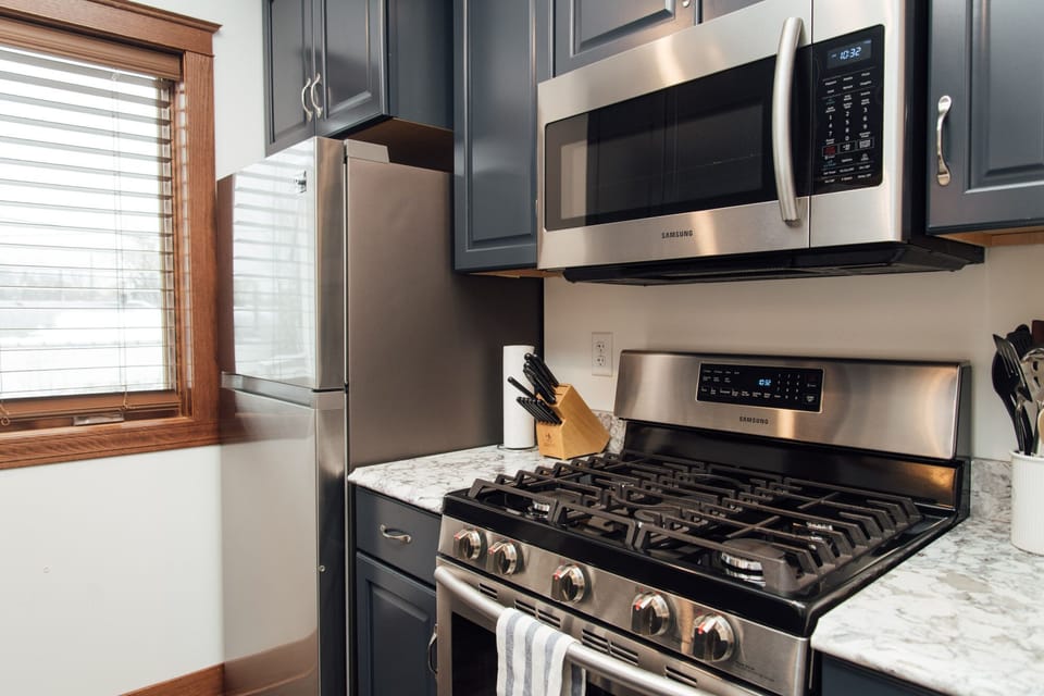 Fully equipped kitchen with pots, pans, and basic kitchen supplies. 