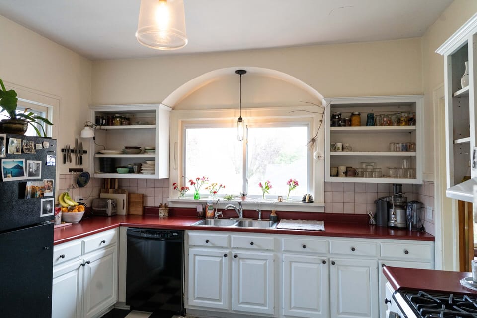 Kitchen with dishwasher, bright light, and open cabinetry 