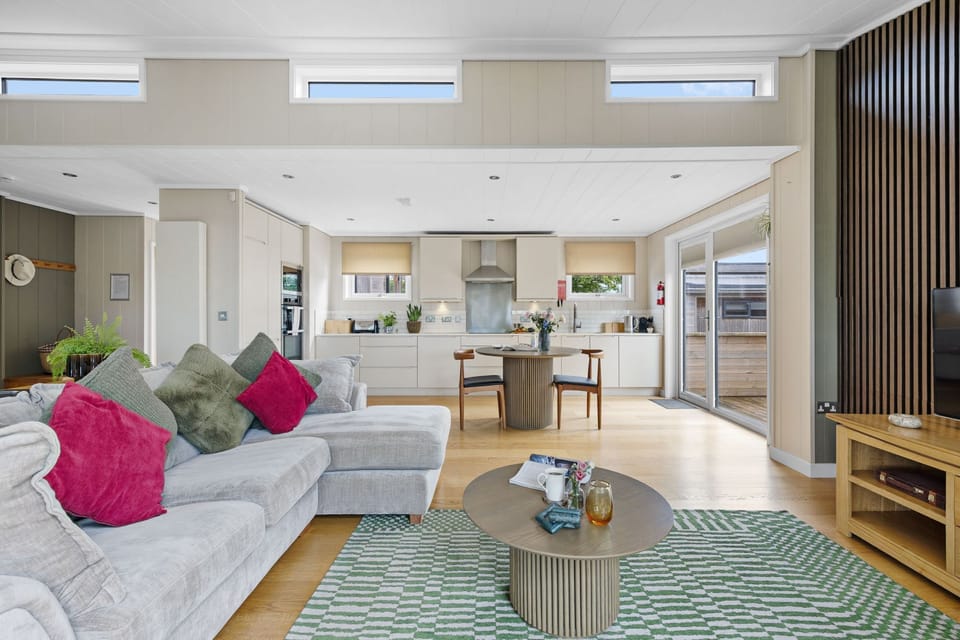 Open plan lounge and kitchen area with dining table for 2  - Amber Lodge