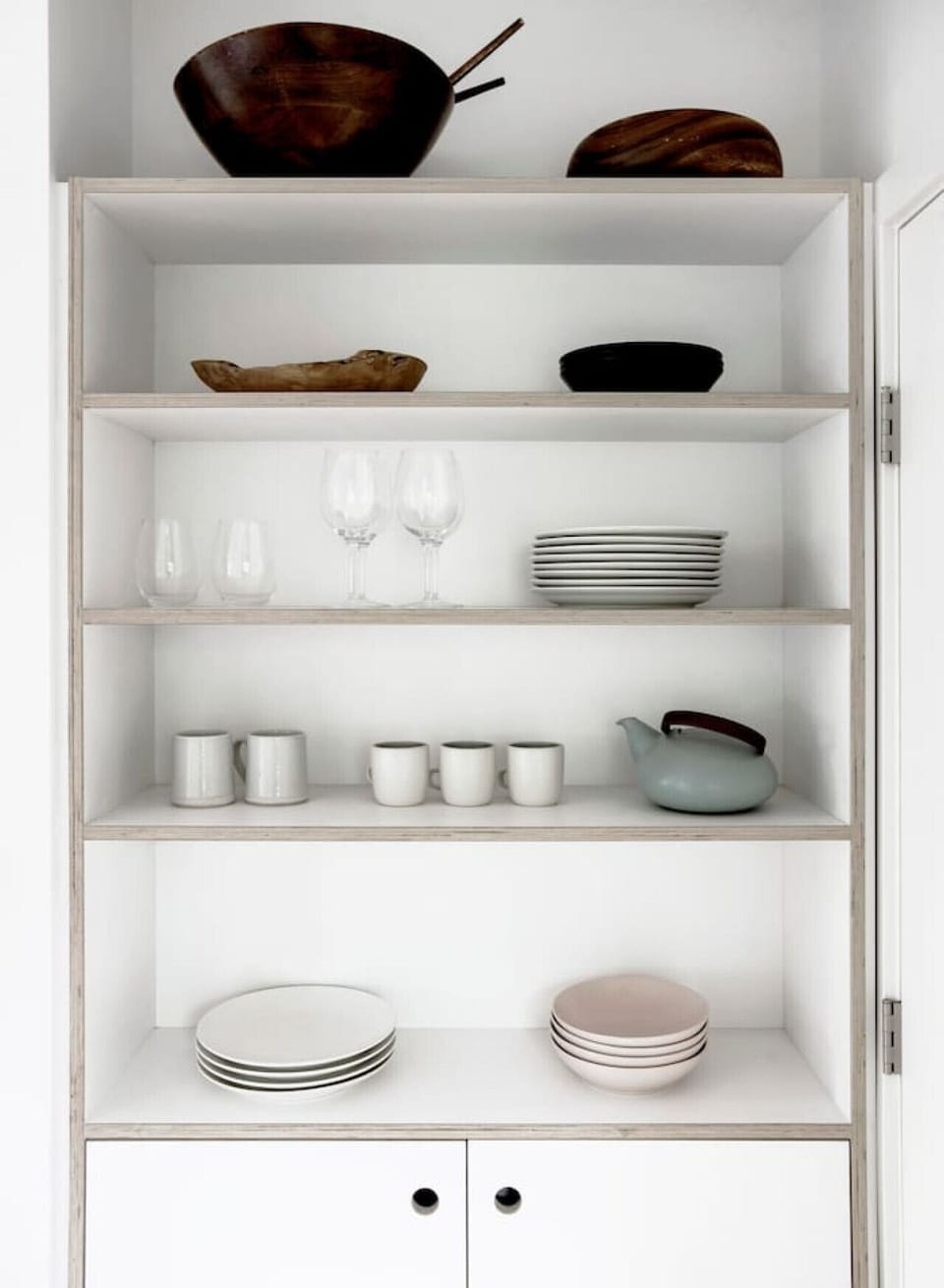 Stylish storage—beautiful kitchen cabinet with dishware.