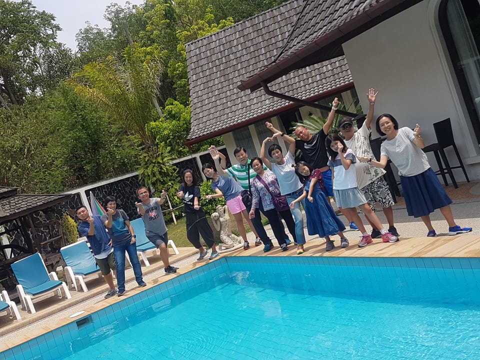 A group of guests is very happy to finally arrive the villa.