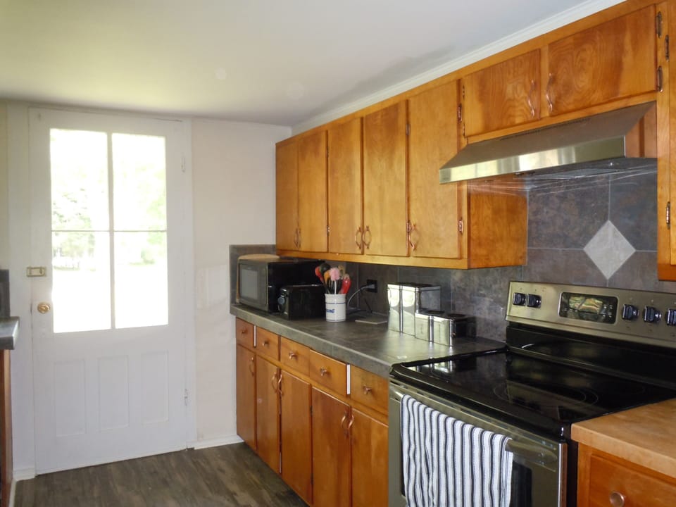 Kitchen countertop, stove and oven.