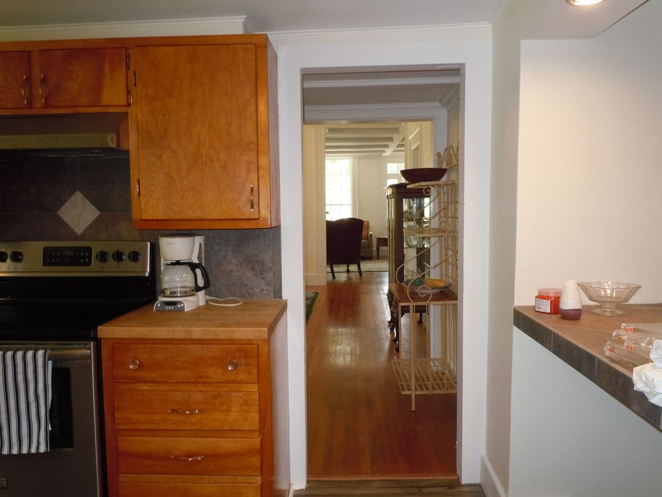 View from Kitchen to dining room, living room and front door with countertop.