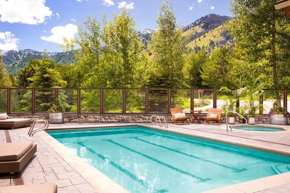 Summer transforms the outdoor pool into a mountain-view swim spot.
