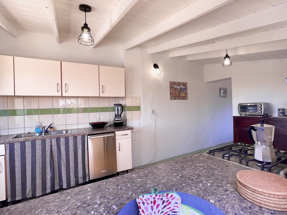 Kitchen doorway leads to dining and opposite Dutch door opens to pool