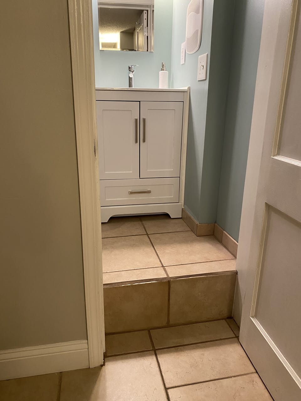 There is a single 11 inch step to enter the bathroom. 