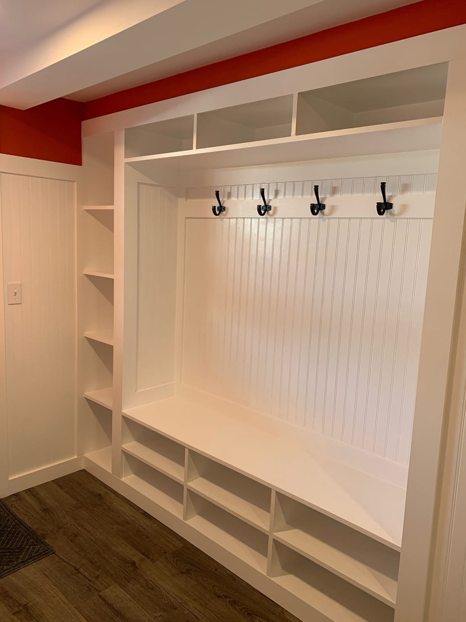 Build-ins storage coat rack in basement mud room. 