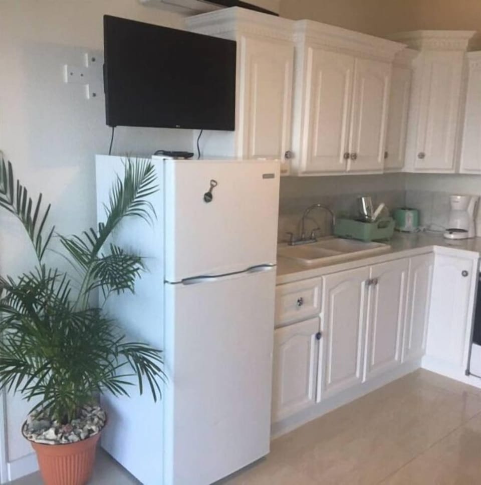 Ample cupboards to keep things organized in this petite kitchen. 