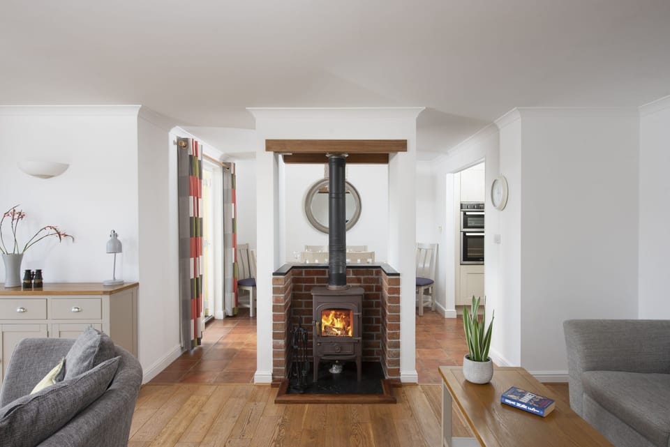Waterfront House, Malpas. Ground floor: Cosy sitting room with wood burning stove
