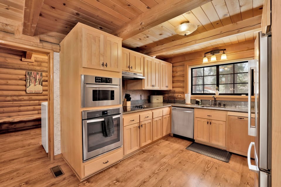 Fully equipped cabin kitchen with ample cabinetry, stove, fridge, microwave, and coffee maker—perfect for cooking meals, morning coffee, and feeling right at home on your stay.