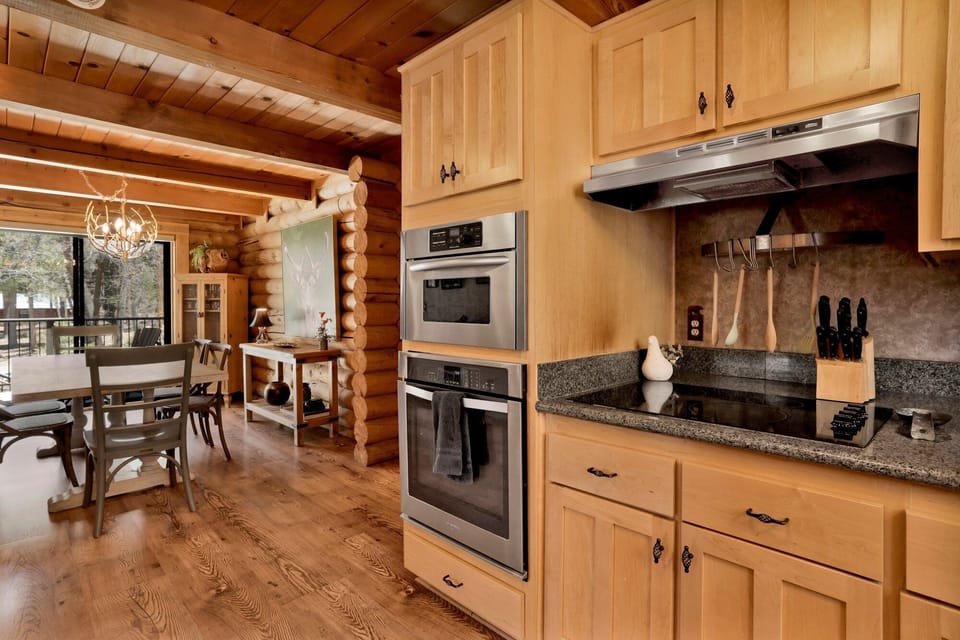 Fully equipped cabin kitchen with ample cabinetry, stove, fridge, microwave, and coffee maker—perfect for cooking meals, morning coffee, and feeling right at home on your stay.