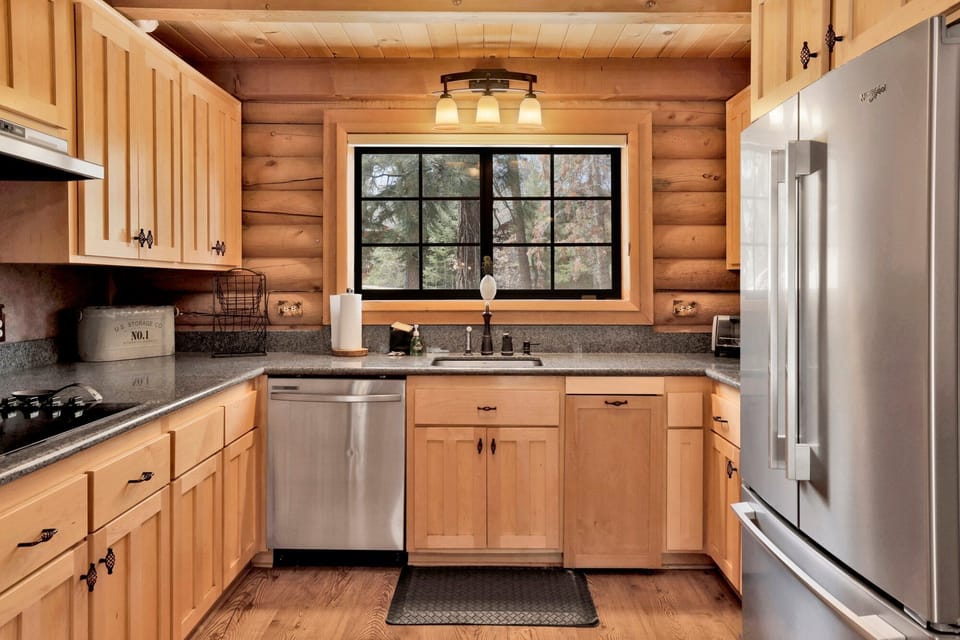 Fully equipped cabin kitchen with ample cabinetry, stove, fridge, microwave, and coffee maker—perfect for cooking meals, morning coffee, and feeling right at home on your stay.