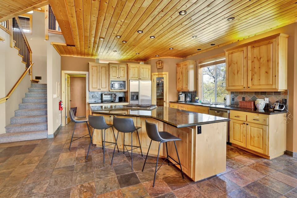 Fully equipped cabin kitchen with ample cabinetry, stove, fridge, microwave, and coffee maker—perfect for cooking meals, morning coffee, and feeling right at home on your stay.
