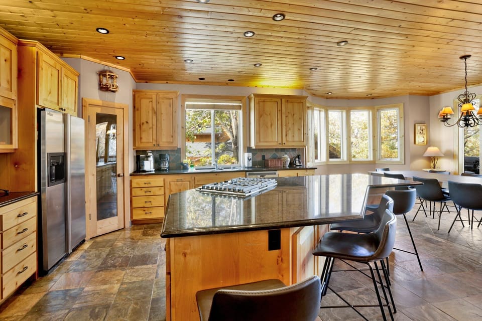 Fully equipped cabin kitchen with ample cabinetry, stove, fridge, microwave, and coffee maker—perfect for cooking meals, morning coffee, and feeling right at home on your stay.
