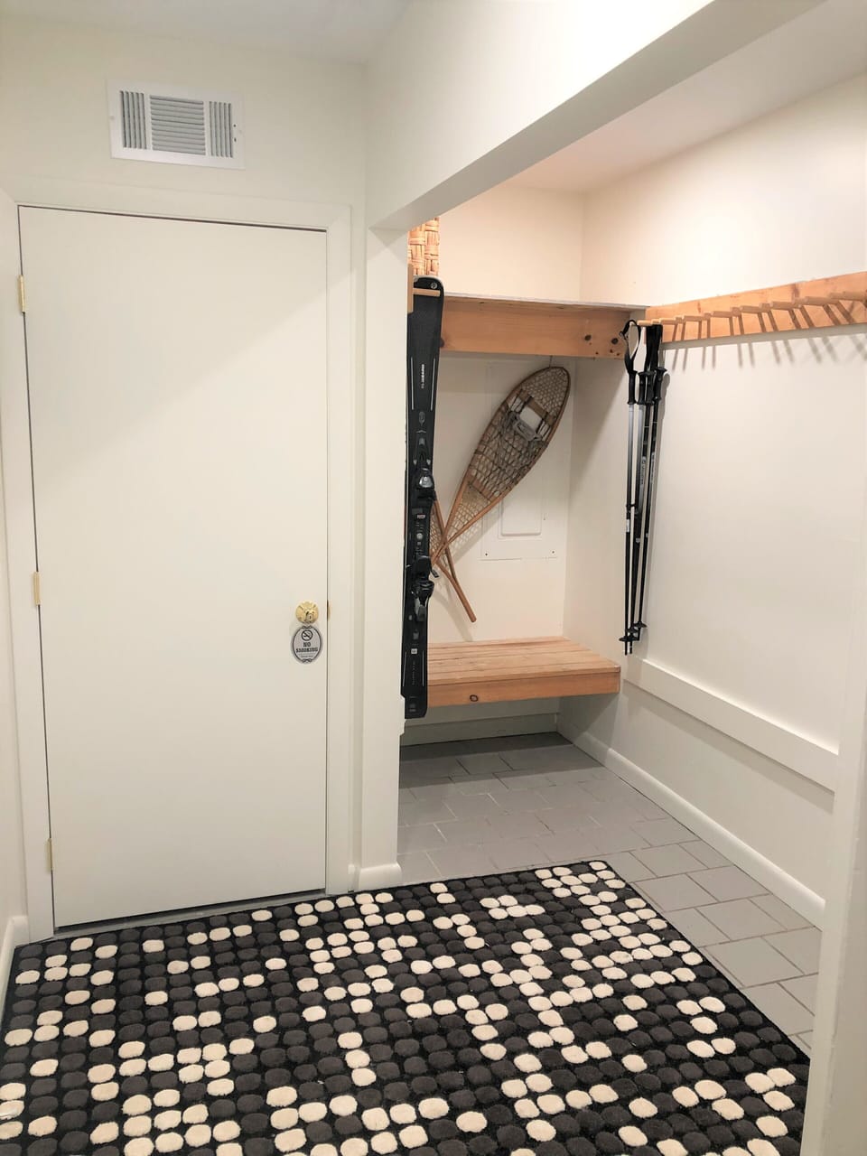 Private apartment door inside mud room. Ski racks conveniently located.