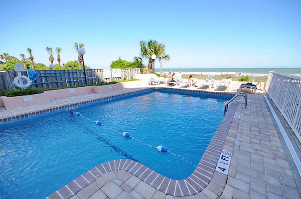 Feel the warm breeze from the ocean as you take a dip in the pool.